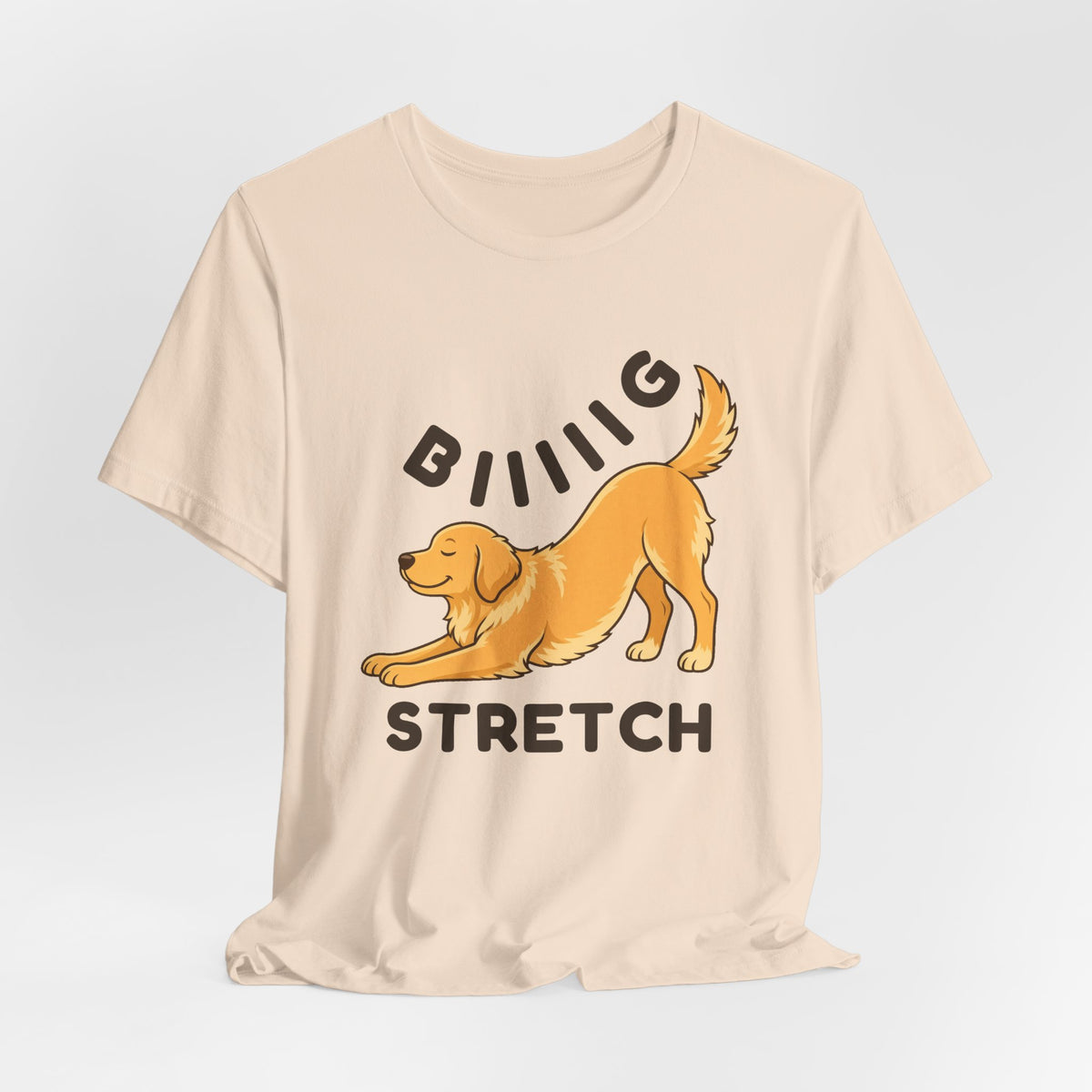 Soft Cream t-shirt with the "Big Stretch Golden Retriever" design, flat lay