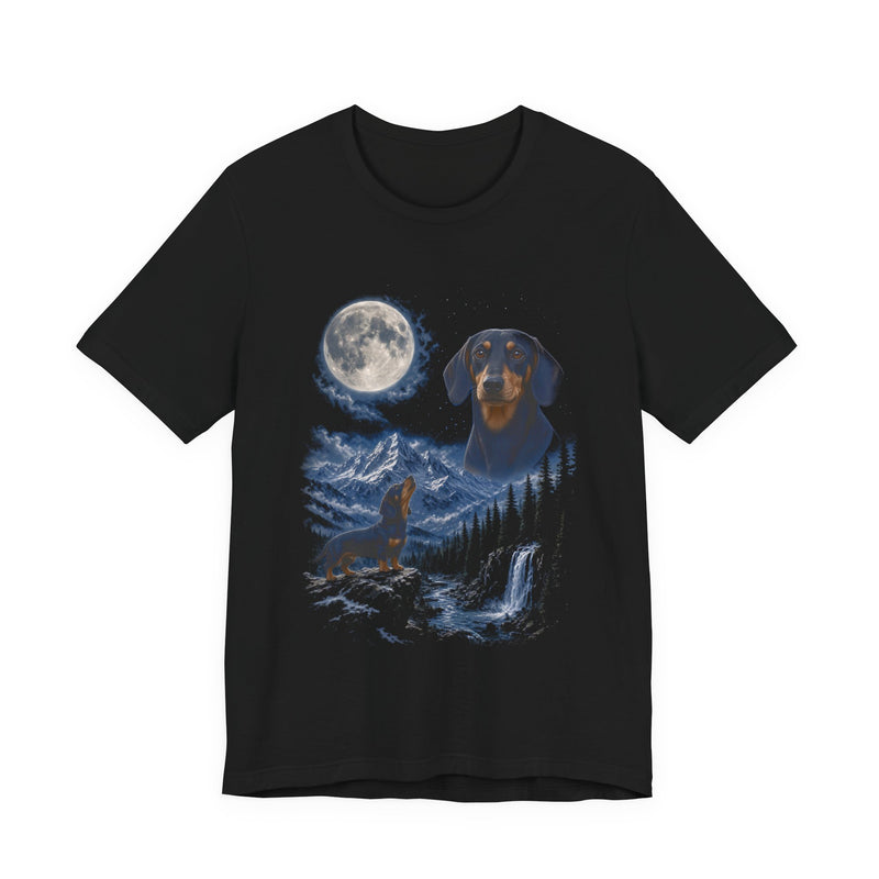 Black t-shirt with a photoreal miniature dachshund under a full moon and a second miniature dachshund howling on a cliff over mountains and a waterfall, front view