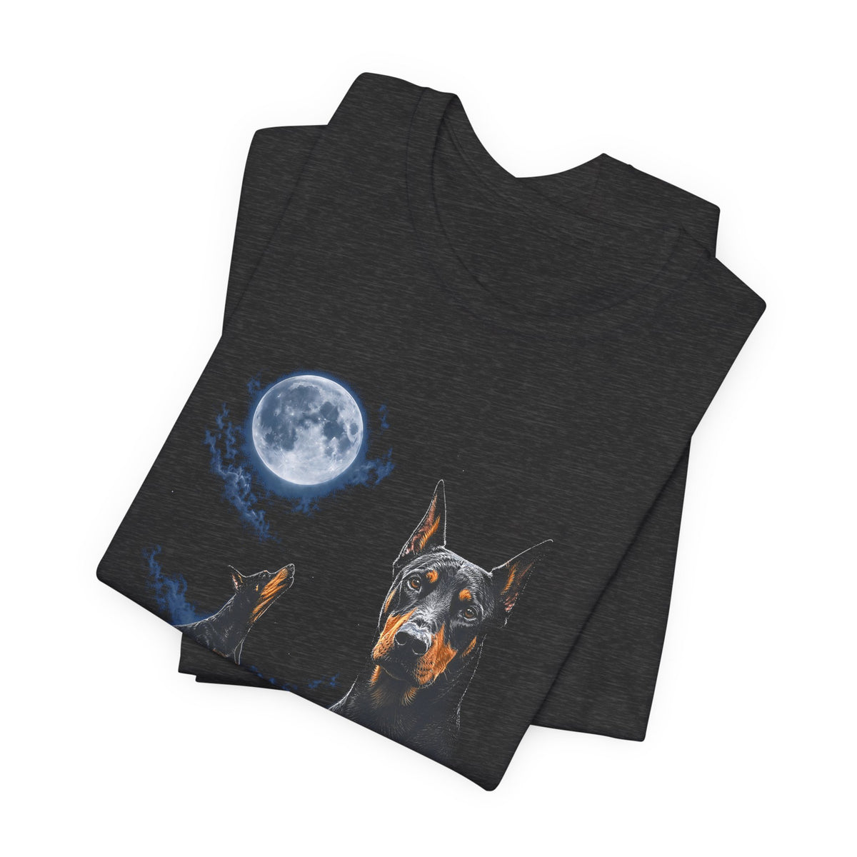 Dark Grey Heather t-shirt with a photoreal Doberman under a full moon and a second Doberman howling on a cliff over mountains and a waterfall, folded