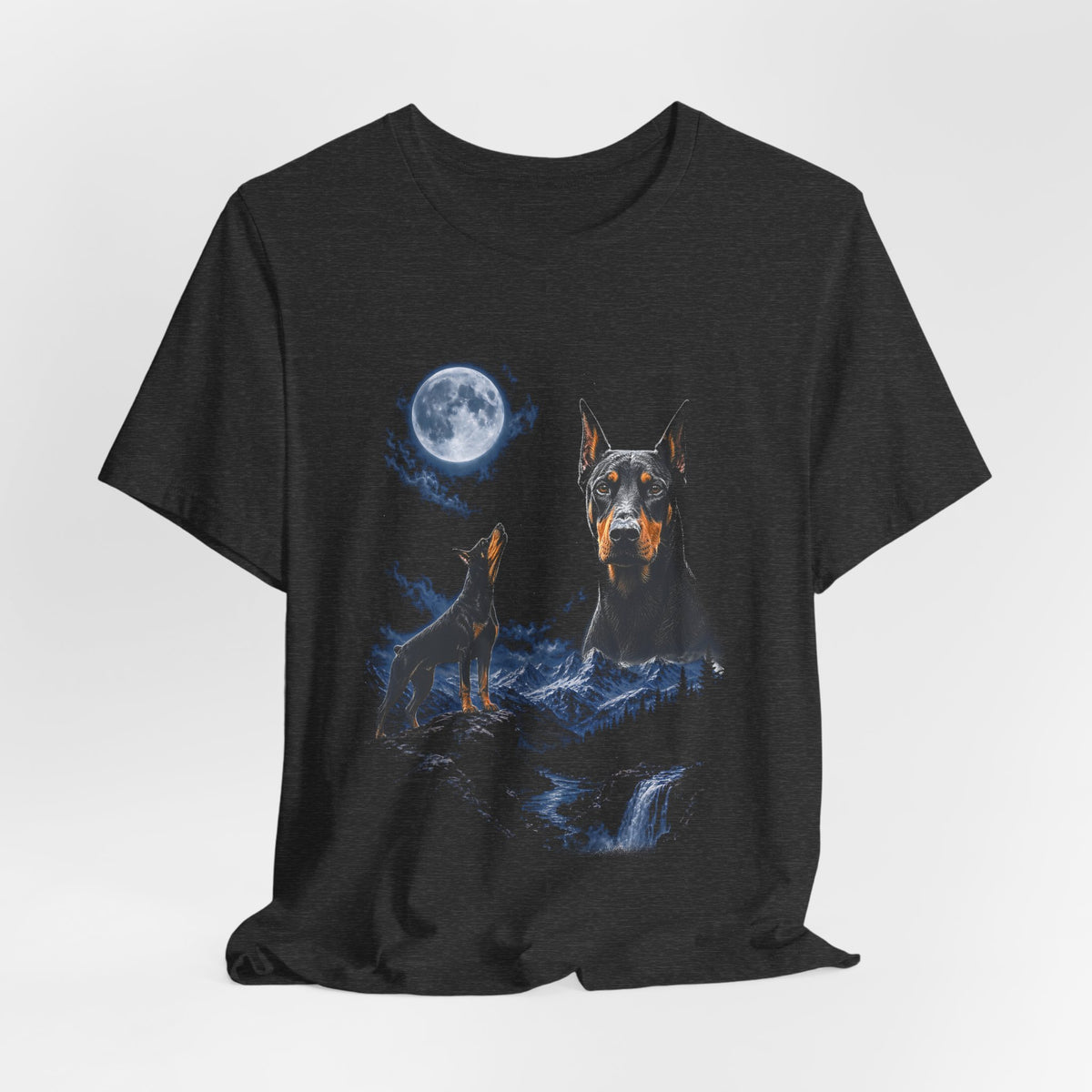Dark Grey Heather t-shirt with a photoreal Doberman under a full moon and a second Doberman howling on a cliff over mountains and a waterfall, flat lay