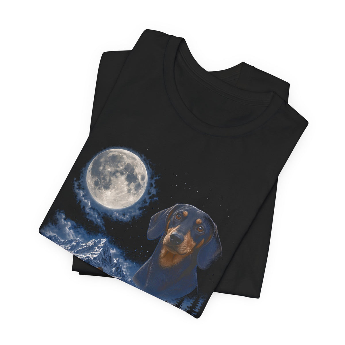 Black t-shirt with a photoreal miniature dachshund under a full moon and a second miniature dachshund howling on a cliff over mountains and a waterfall, folded